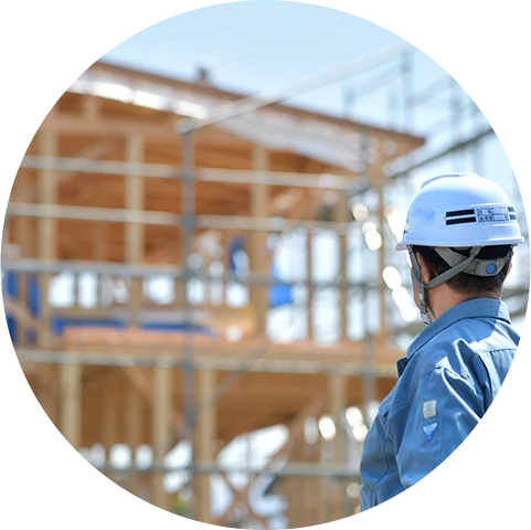 建築工事のイメージ。作業員が建設中の木造建築を確認。看板設置に伴う建築作業もワンストップで対応します。